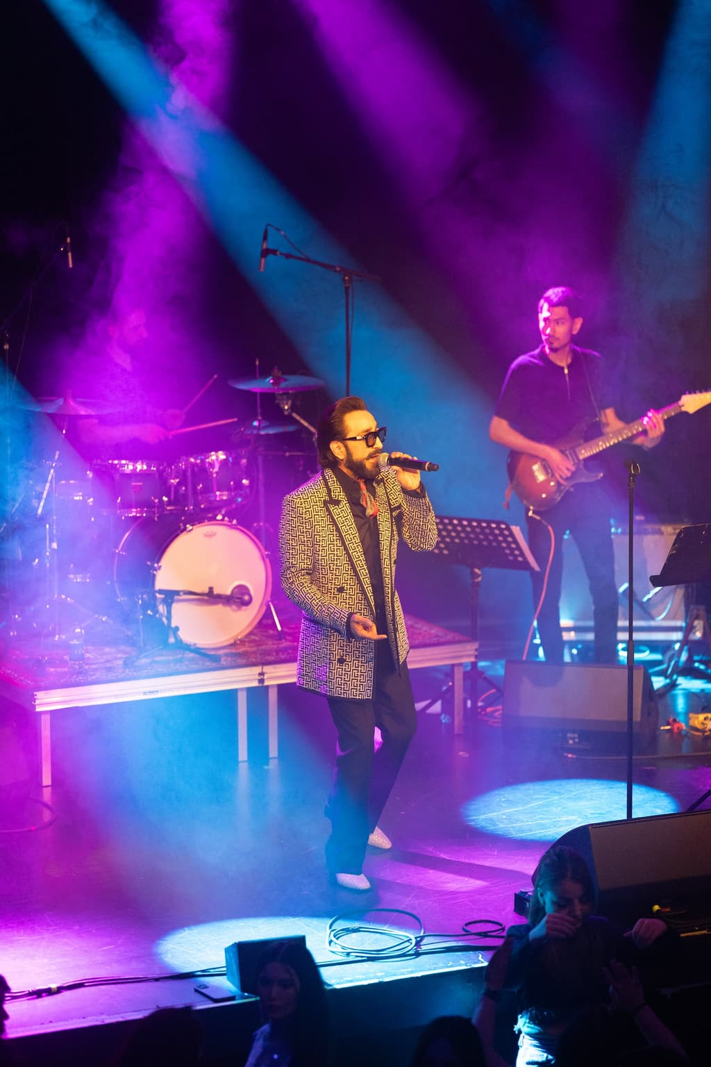 Habib Qaderi performing under purple and blue stage light