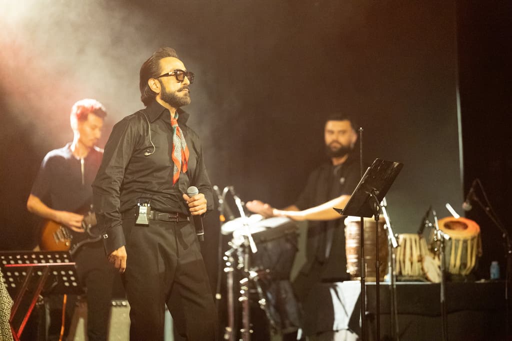 Habib Qaderi mid-performance with his guitarist
